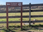 Kinder - Sign pointing to Sports Complex with goat